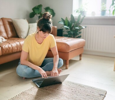 Nainen käyttää kannettavaa tietokonetta
