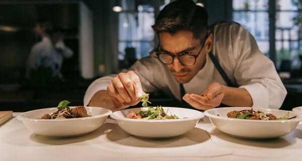 man preparing food in restaurant